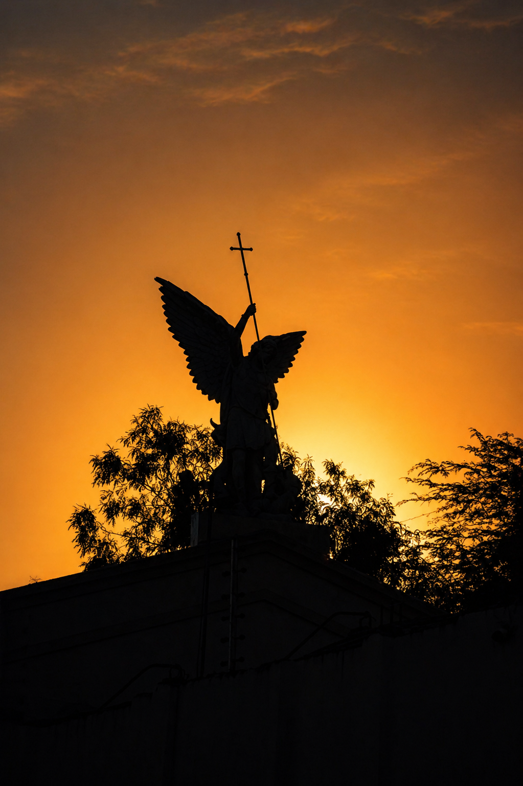 Anjo em silhueta segurando uma cruz contra o céu iluminado